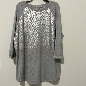 Tunic jersey knit top with shimmery metallic pattern.